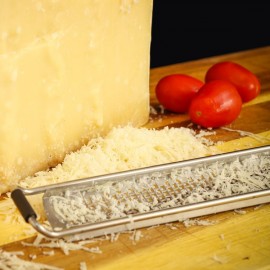 Parmigiano Reggiano Prodotto di Montagna stagionato oltre 24 mesi grattugiato con pomodori di fianco